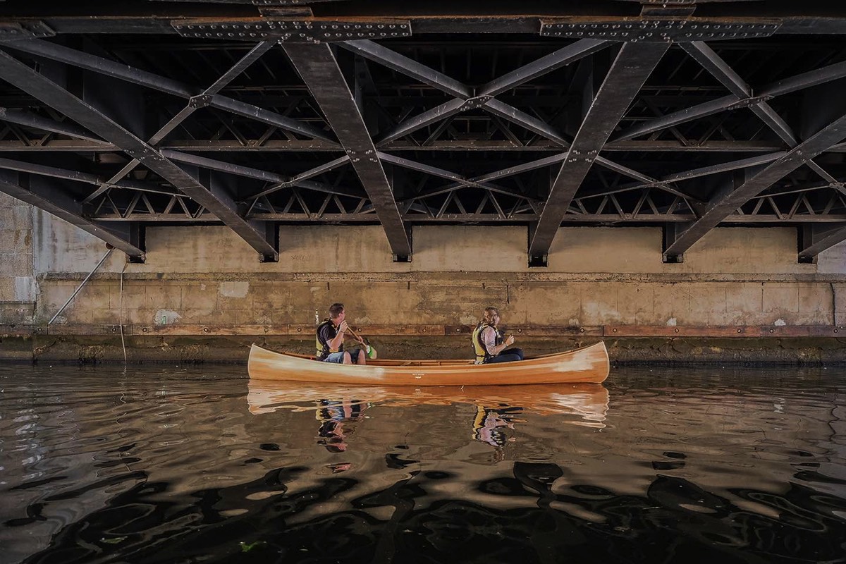 Cedar handmade canoe under the Biržos bridge in Klaipeda