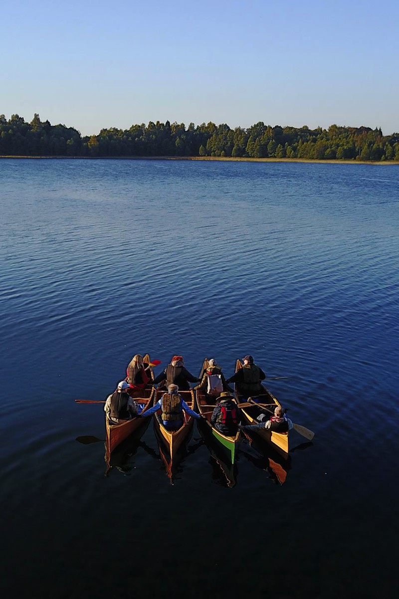 Four canoes stuck together during Crystal Waters tour in lake Plateliai